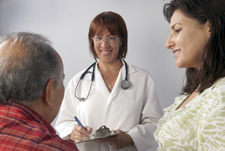 elderly man and caregiver talking with doctor