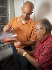 caregiver making smoothie for elderly  loved one