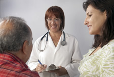 doctor talking to elderly couple