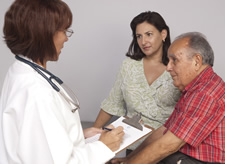 doctor talking to senior and caregiver