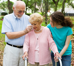 elderly woman crying while walking with family