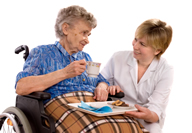 elderly woman in wheelchair talking with nurse