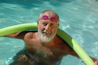 elderly man swimming in pool 